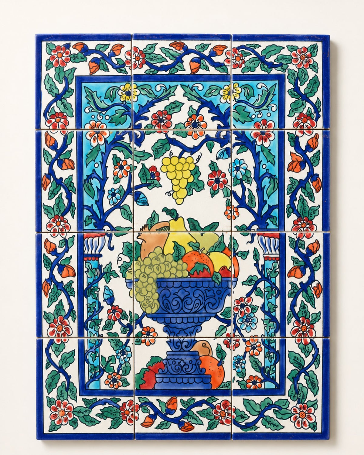 Decorative tiled panel with a blue fruit bowl and floral border, supplied image.