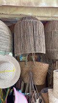 Domed woven lampshade with straight sides, central upper item in the supplied photograph.